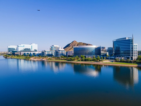 a drone image overlooking Tempe Town Lake, Arizona looking at the downtown Tempe glass buildings