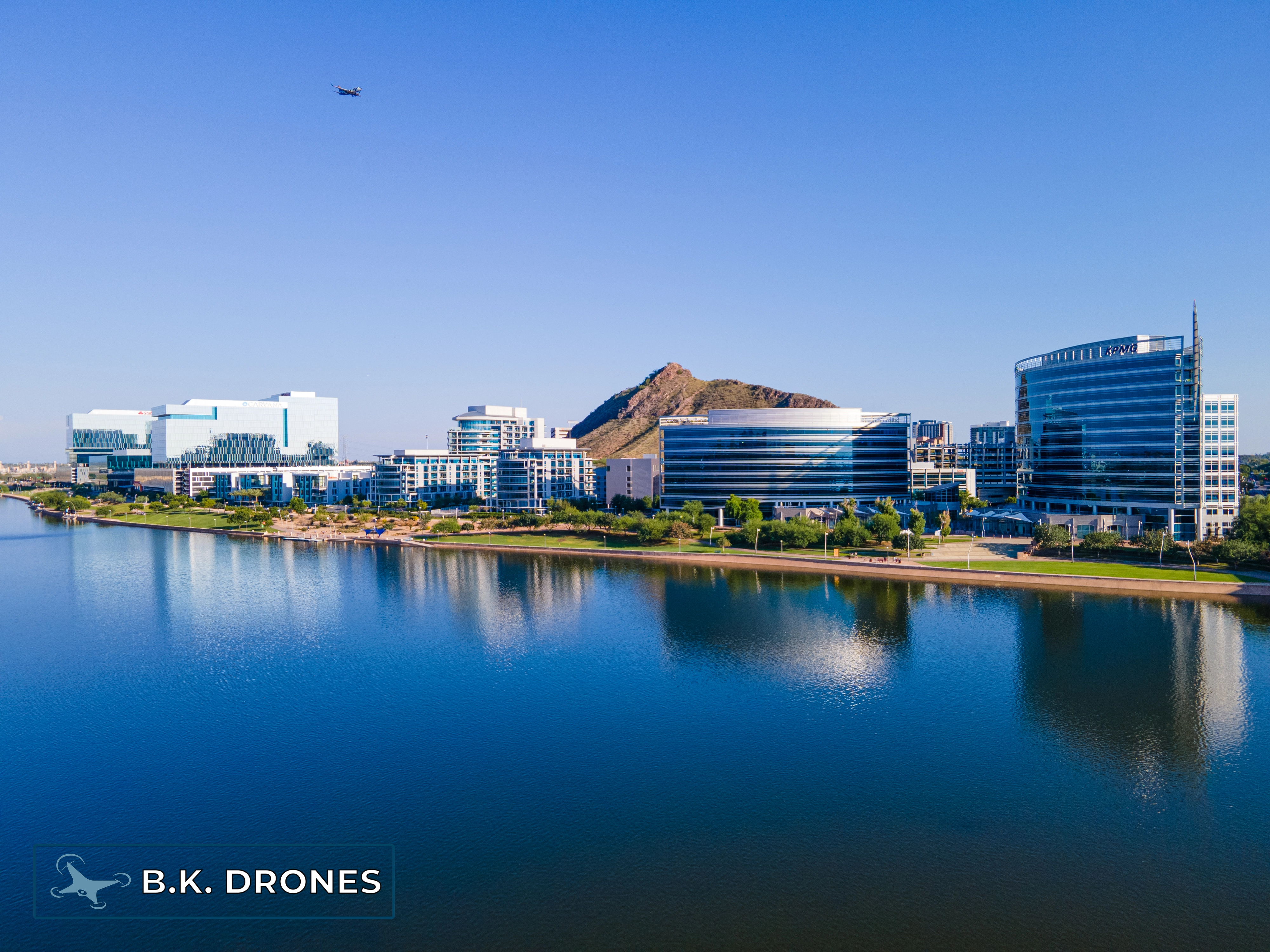 a drone image overlooking Tempe Town Lake, Arizona looking at the downtown Tempe glass buildings