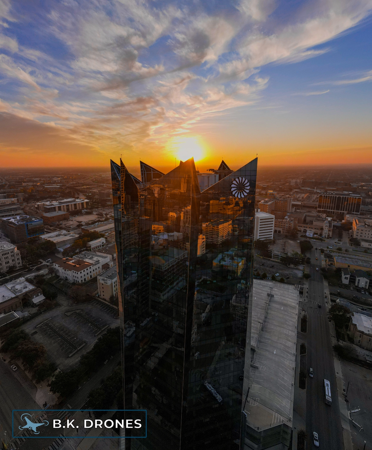 a drone image showing the Frost Bank Tower at sunset in downtown San Antonio, Texas